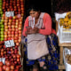 A vendor waits for customers at her produce stand in La Paz, Bolivia